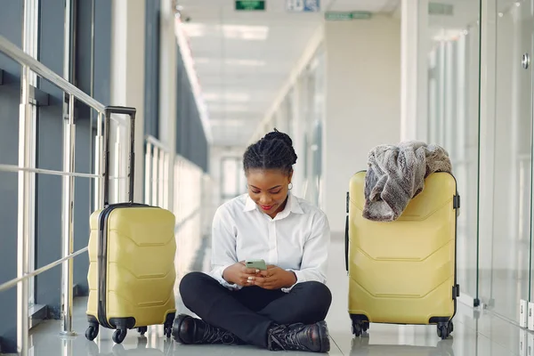 Black woman with suitcase at the airport