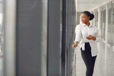Ofiste dizüstü bilgisayarı olan siyahi bir kadın.