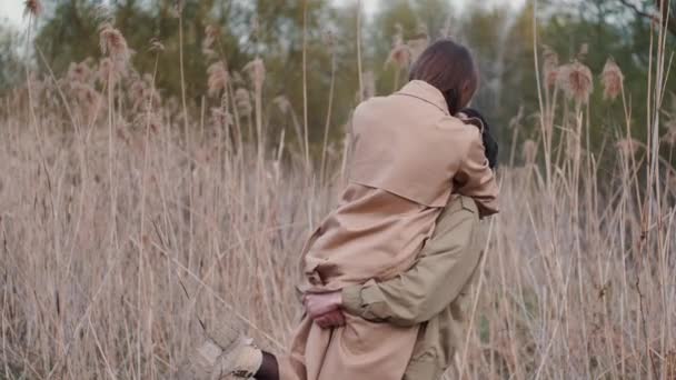 Mladý pár v béžových kabátech tráví čas venku — Stock video
