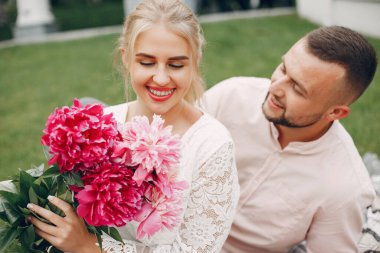 Beautiful couple spend time in a summer garden