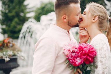 Beautiful couple spend time in a summer garden
