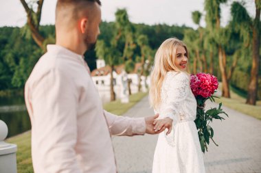 Beautiful couple spend time in a summer garden