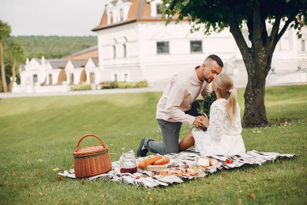 Beautiful couple spend time in a summer garden — Stok fotoğraf