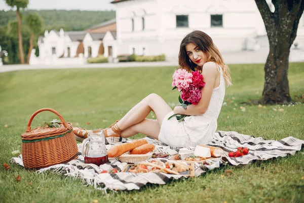 Elegant and stylish girl in a summer garden — Stock Photo, Image