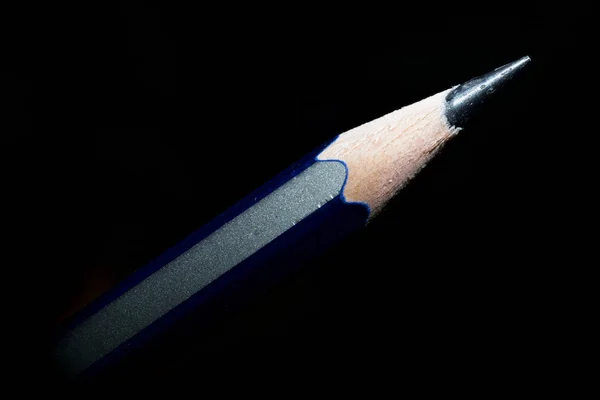 Black pencil on black background — Stock Photo, Image