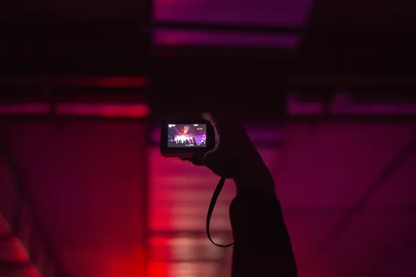 hand with a camera in the crowd