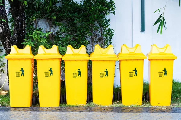 Large yellow trash bin placed 6 side by side. — Stock Photo, Image