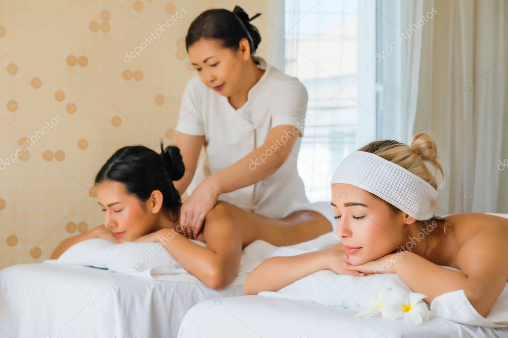 Asia beautiful woman during massage with essential oil in room s