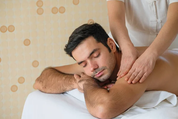 Piękny mężczyzna podczas masażu z olejkiem eterycznym w pokoju spa — Zdjęcie stockowe