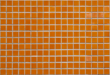 Dark brown and red chipped wall tiles of the building background