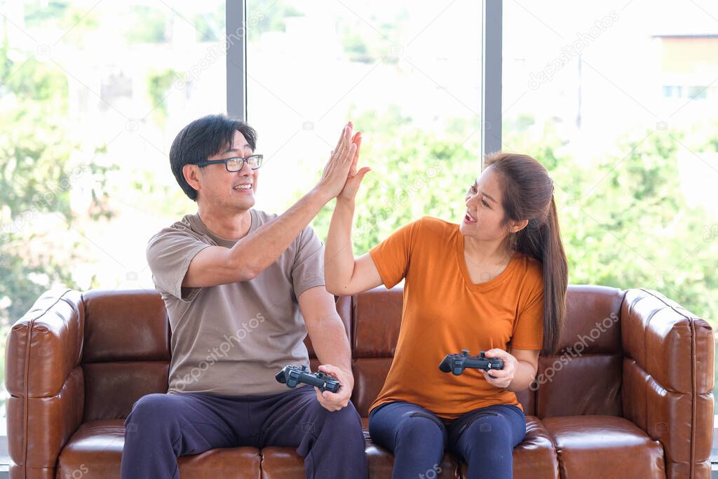 Elderly Asian men and women playing games at home