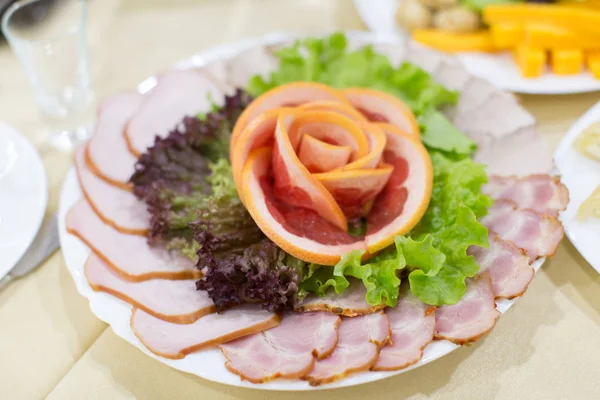 Dinning table set with baked sliced ham Stock Picture