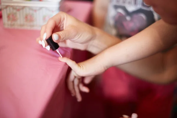 Young girl on a manicure. paint nails — Stock Photo, Image