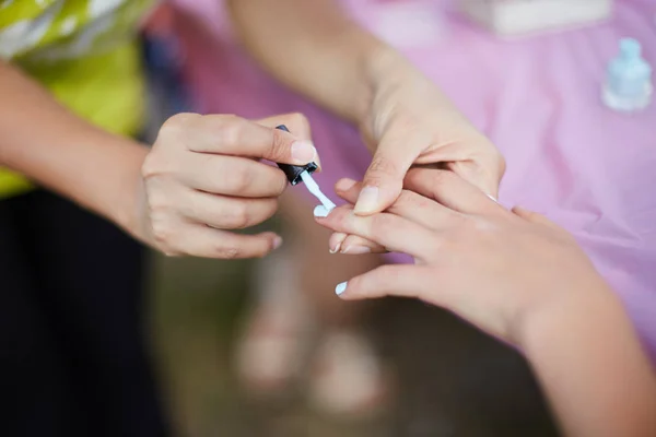 young girl on a manicure. paint nails