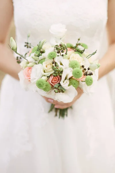 Bouquet de mariée. Bouquet entre les mains de la mariée . — Photo