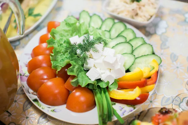 Tomato, cucumber, white cheese with salad on plate. — Stock Photo, Image