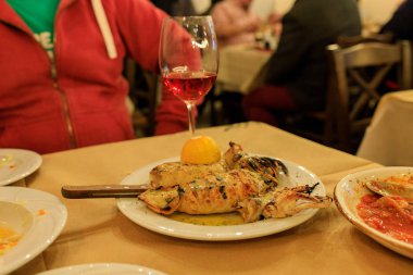 grilled squid on a plate with lemon