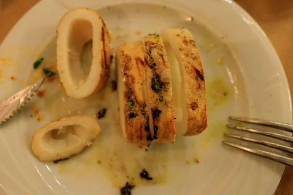 grilled squid on a plate with lemon