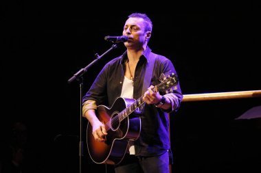 Alex Britti gitar çalıyor ve şarkı söylüyor