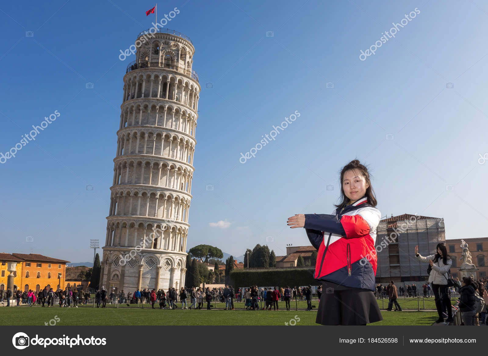 Tourists Posing In Front Of The Leaning Tower Of Pisa Editorial