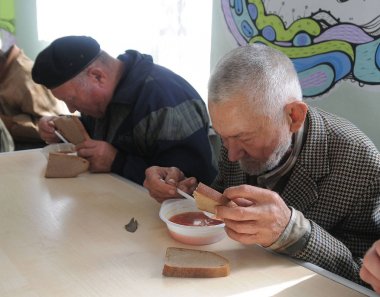 Pensioners and the poor in a soup kitchen for the poor, pensioners and homeless in Kyiv, September 28, 2016    clipart