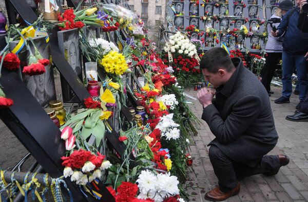 A man prays at the memorial of activists of Euromaidan or Heroes of Heavenly Hundred who were killed in Kiev, February 20, 2020. 