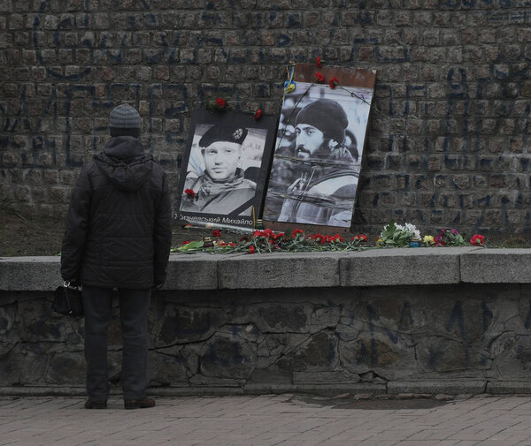 Flowers from photographs of the Heroes of Heavenly Hundred by Sergey Nigoyan and Mikhail Zhizhevsky, on Institutskaya Street, in Kiev, February 20, 2020. 