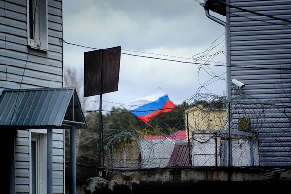 the flag of Russia on the background of the fence