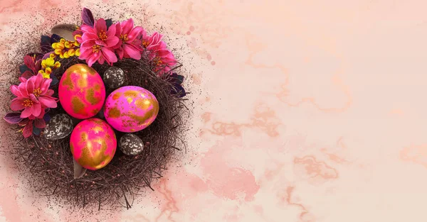 Easter festive elegant background, pink eggs painted with a golden patel in a twisted nest, a branch of a blossoming red apple tree, feathers, place for text