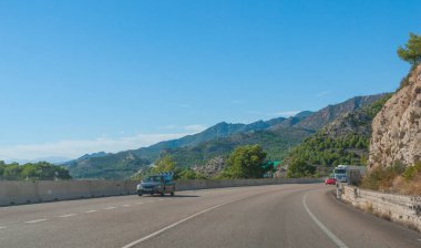 Otomobil kıyı eteklerinde ve Ispanya Dağları üzerinden karayolu aşağı motor.