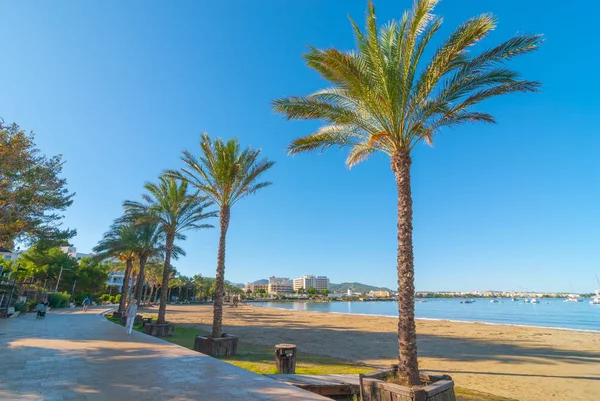 Persone a piedi accanto alla spiaggia di Sant Antoni de Portmany, Ibiza, Spagna . — Foto Stock