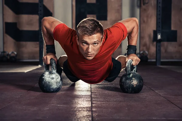 Handsome muscular man doing push ups