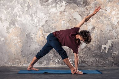 Young man practicing yoga  clipart