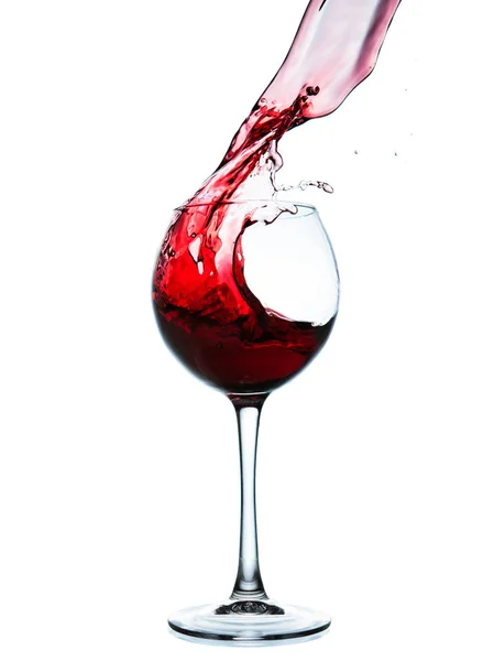 Red wine splashing in a glass — Stock Photo, Image