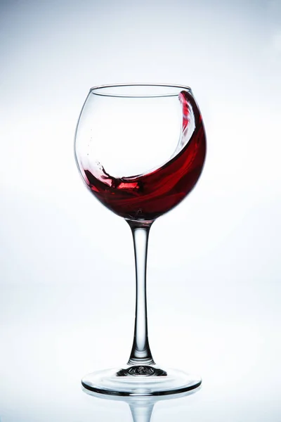 Wine splashing in glass — Stock Photo, Image
