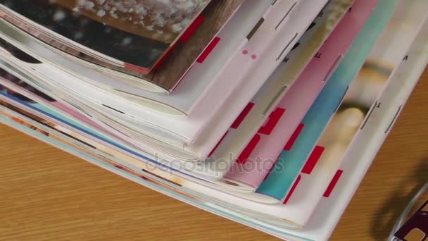 Magazines on table with eyeglasses — Stock Video