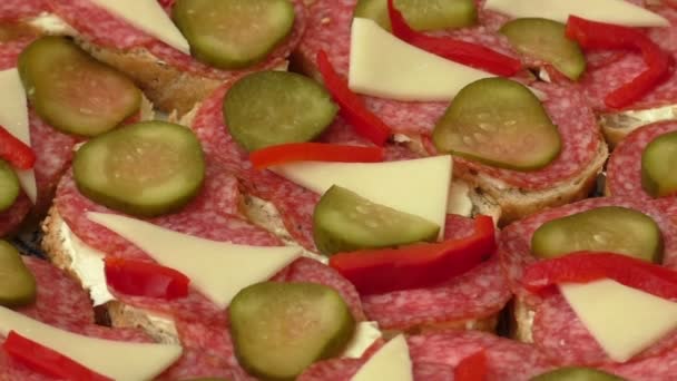 Small snacks canape with salami, cheese and pickle — Stock Video