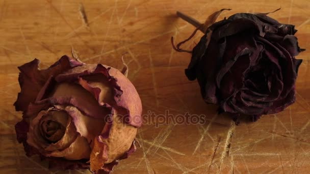 Висушена квітка троянди на дерев'яному столі — стокове відео