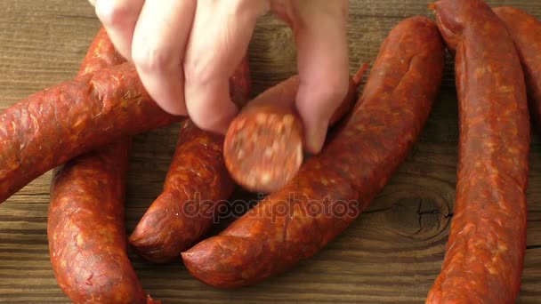 Fresh homemade sausages lying on wooden board — Stock Video
