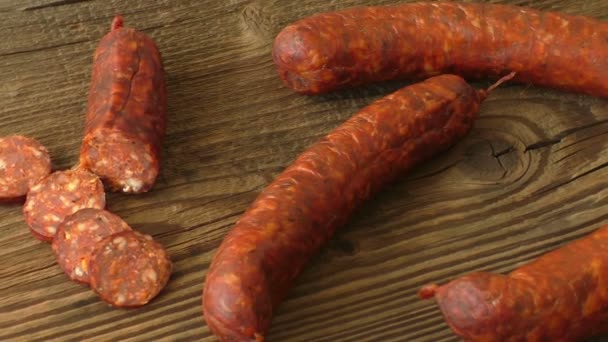 Homemade sausages on a wooden background — Stock Video