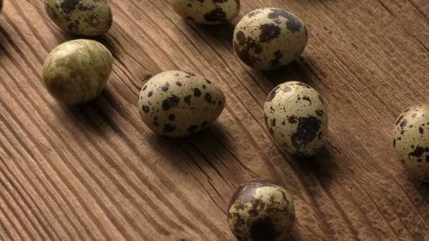 Quail eggs on a wooden board — Stock Video