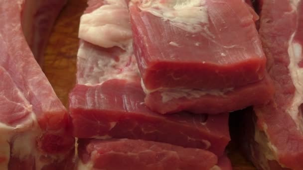 Costillas de cerdo crudas en una tabla de cortar — Vídeo de stock