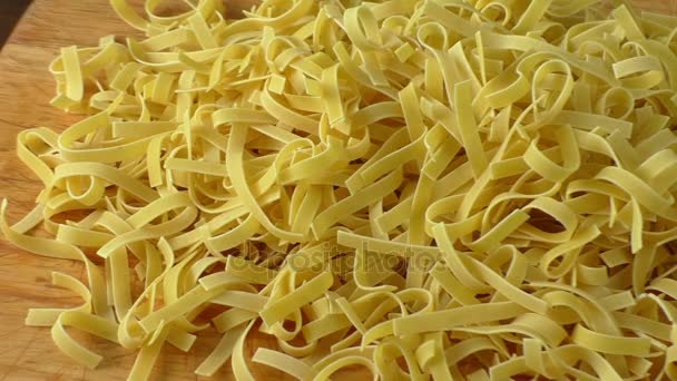 Raw noodles pasta on wooden board — Stock Video