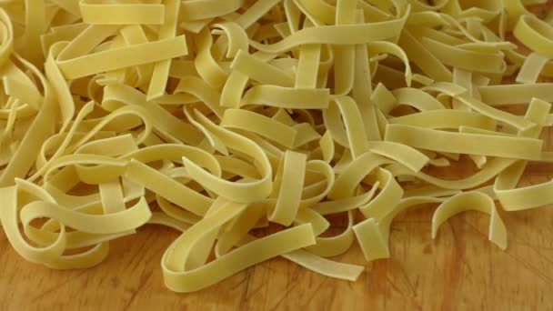 Raw noodles pasta on wooden board — Stock Video