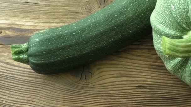 Zucchini (Cucurbita pepo) round zucchini (courgette) on wooden background — Stock Video