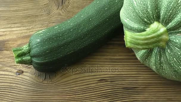 Fresh zucchini on a natural brown wooden background — Stock Video