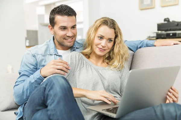 Young couple making the most of new technologies in their house — Stock Photo, Image