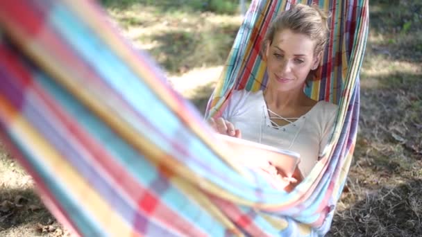 Cheerful Young Woman Using Tablet Hammock — Stock Video