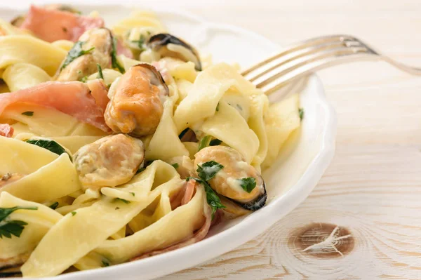 Pasta (pappardelle) con cozze, prosciutto e formaggio . — Foto Stock