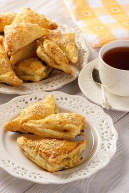 Puf böreği üçgenler beyaz peynir ve pırasa ile dolu.